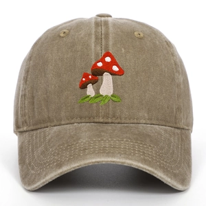 Detailed view of red mushroom embroidery on vintage washed khaki cotton baseball cap