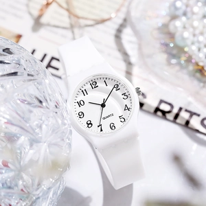 Close-up of white quartz watch with silicone strap and numeric dial in lifestyle setting