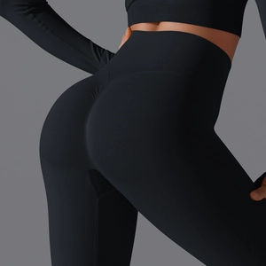 Detail view of high-waist black seamless yoga pants with scrunch butt lifting effect