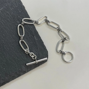 Detail of 925 sterling silver chain bracelet featuring industrial oval links and OT clasp