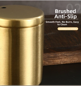 Detailed macro view of gold brushed stainless steel container with non-slip texture surface
