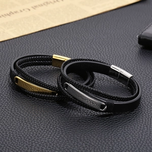 Detail of multi-layer leather braided bracelets with gold and silver titanium steel plates