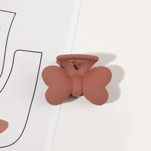 Matte finish butterfly hair claw clip with spring detail shown on a minimalist white card