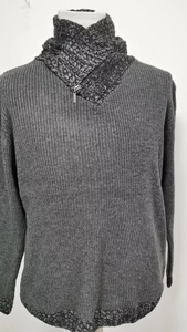 Dettaglio di un maglione da uomo in maglia spessa grigio scuro con collo alto e zip metallica