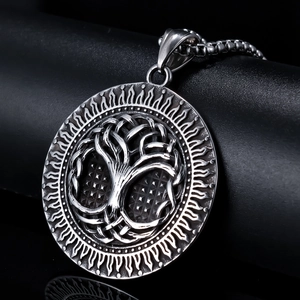 Vintage silver tree of life pendant with nordic viking motifs on a dark leather base