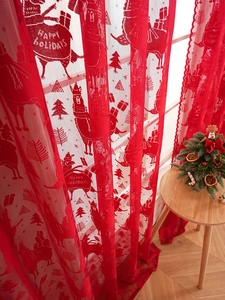 Red Christmas lace curtain featuring reindeer and Happy Holidays lettering in home setting