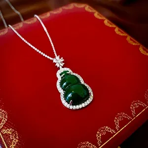 Green resin gourd pendant necklace with white zircon pavé on a red luxury gift box