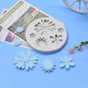 Detail view of round silicone mold with various daisy flower shapes for DIY cake decor