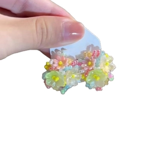 Colorful beaded flower hair clip with pastel pink yellow and blue floral resin beads