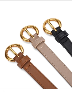 Detailed view of women's PU leather belts with gold round buckles in brown, beige and black
