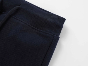 Detail of navy blue yoga shorts showing drawstring waist and elastic waistband