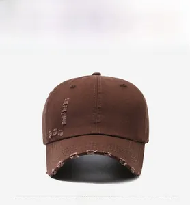 Close-up of distressed vintage coffee brown cotton canvas baseball cap with ripped details