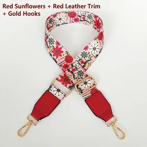 Detail of floral wide shoulder strap with red sun flower pattern and gold metal hooks