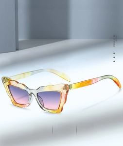 Detail view of cat eye sunglasses featuring wavy lace frames and purple gradient lenses