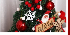 Macro detail of mini Christmas tree with red berries, wooden angels and LED lights