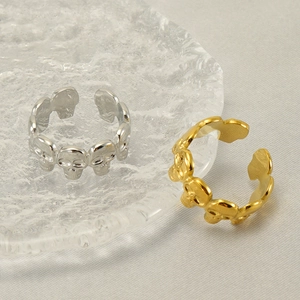 Adjustable skull pattern rings in gold and silver finish on a decorative glass tray