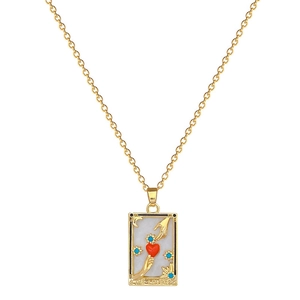 Golden tarot necklace with The Lovers rectangle pendant featuring hands holding a red heart
