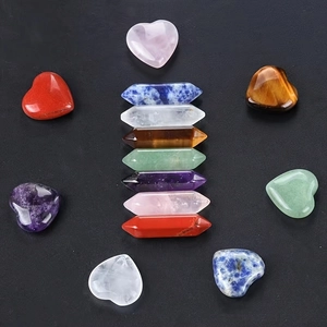 Macro shot of 14pc natural crystal set with heart shapes and hexagonal pillars on black