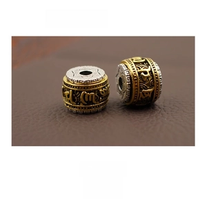 Detail of a 11.5mm rotatable Buddhist prayer bead with Six-Word Mantra engraving