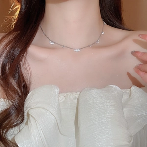Elegant silver stainless steel necklace with sparkling zircon pendants on model neck
