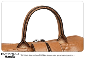 Detail of reinforced brown leather handles and silver metal zippers on a travel backpack