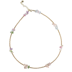 Colorful bohemian crystal stone necklace with a gold chain on a white background
