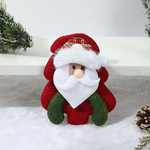 Detail of plush Santa Claus ornament with soft white fur and festive green textile accents