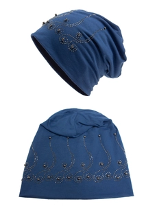 Close-up of dark blue knitted beanie with intricate rhinestone spiral pattern and beads