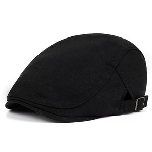 Close-up of black flat cap showing cotton texture and silver metal adjustable buckle
