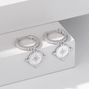 Close-up of S925 sterling silver hoop earrings with embossed star pendant and zircon pave