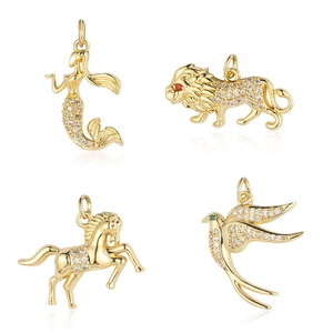 Golden animal charms with cubic zirconia including mermaid, lion, horse, and bird pendants