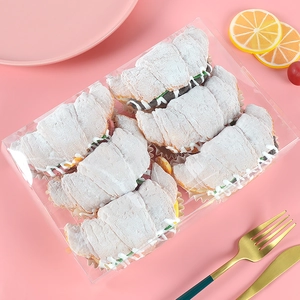 Six pink artificial croissants with sugar texture in clear box for display