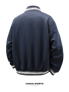 Back view of navy blue varsity jacket featuring white striped ribbed hem and cuffs