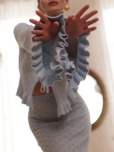 French vintage light blue knit set with ruffled sleeves and matching skirt on model