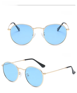 Detail view of round polarize sunglasses with gold metal frames and blue tinted lenses