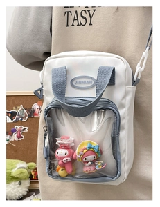 White and blue ita bag with transparent PVC window for doll display worn by model
