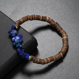 Macro view of bohemian coconut shell beads with blue lapis lazuli stones and gold accents