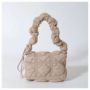 Beige quilted nylon crossbody bag featuring ruched handles and puff texture design