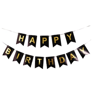 Detailed view of black happy birthday banner with gold foil lettering for party decor