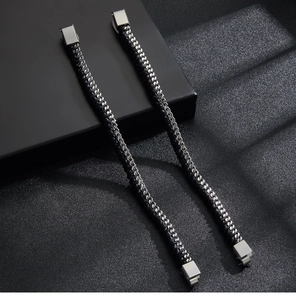 Close-up of black braided leather bracelet with magnetic stainless steel clasp detail