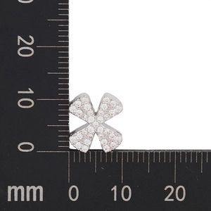 Macro detail of silver X-shaped pendant with cubic zirconia and measurement scale