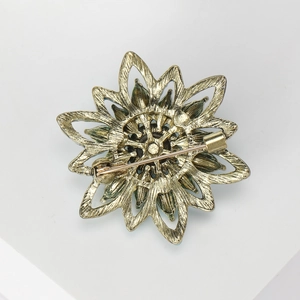 Vintage Turkish gold metal flower brooch showing antique finish and back pin structure