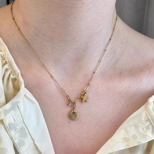 Collier doré avec pendentifs étoile de mer et coquillage et petit cristal de style marin