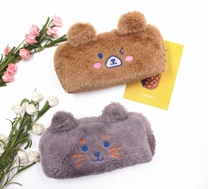 Close-up of soft plush bear and cat stationery pouches with delicate facial embroidery