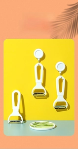 Detail of stainless steel vegetable peeler with hanging hook for kitchen storage