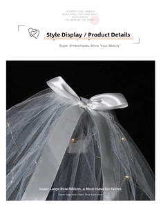 Detail of white tulle veil with large satin bow and integrated LED fairy lights