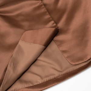 Detailed view of the smooth brown satin fabric with professional stitching and silk finish