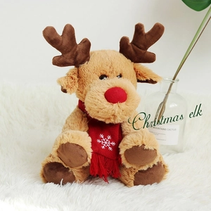 Detailed view of a plush Christmas elk with a red nose and snowflake embroidered scarf
