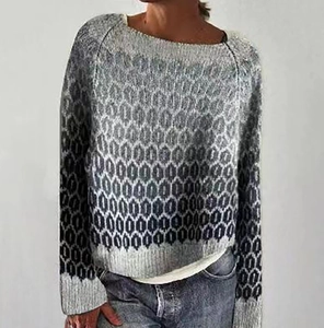 Detail of grey and white honeycomb knit texture on a long sleeve crewneck sweater