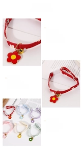 Detailed view of adjustable floral pet collars with sunflower charms and bells